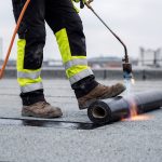 Professional Roofer Installing Bituminous Waterproofing Membrane